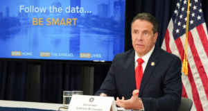 Gov Andrew Cuomo at his daily briefing, slide says follow the data, be smart.