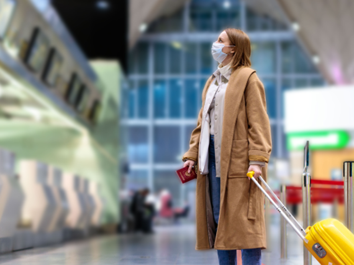 woman at airport with new travel habits